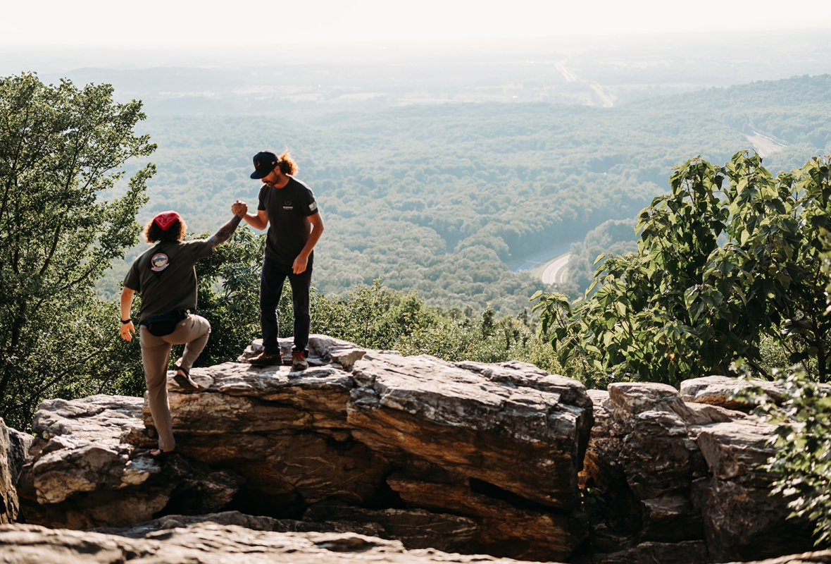 Two men with mountains in the background